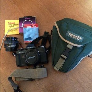 Manual Minolta camera and lens with accessories.